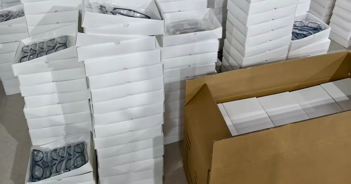 Finished eyewear order boxed and stacked, packed for export at the VISTALUMO factory