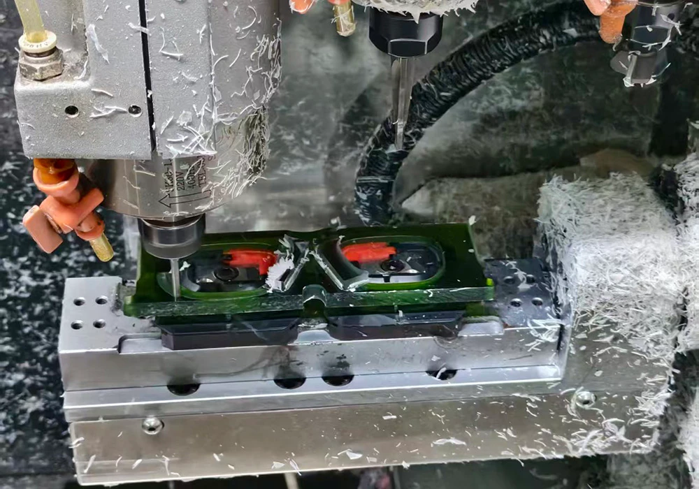 CNC milling machine cutting an acetate frame blank with swarf, at VISTALUMO factory