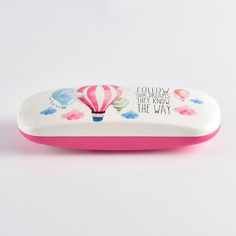 White and pink eyeglass case with printed balloon artwork, closed view