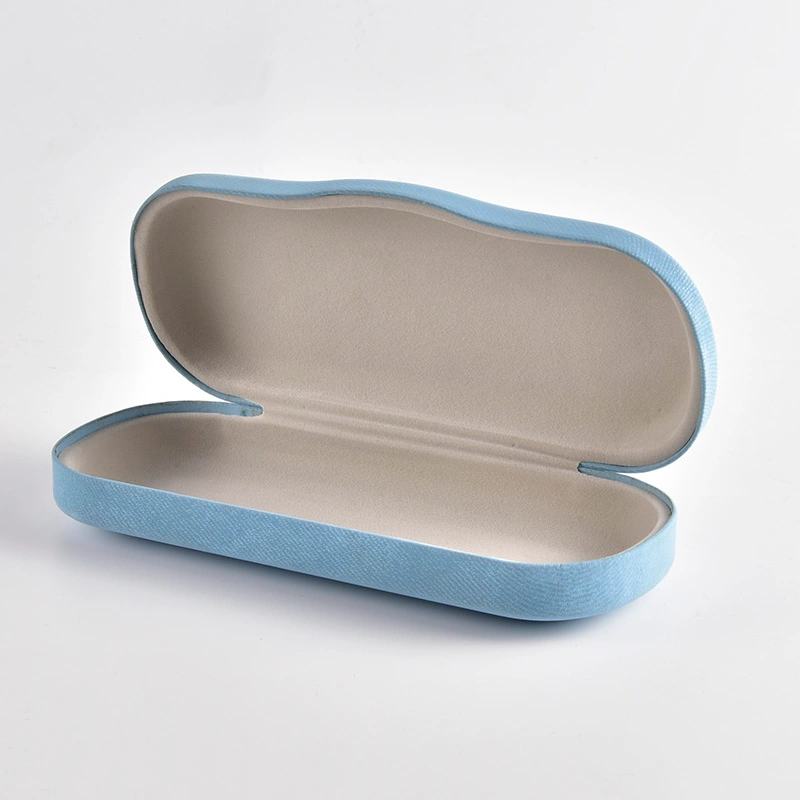 Light blue velvet case shown open with grey flocked lining